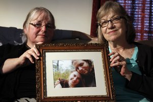 FILE- In this June 4, 2014, file photo, mother's Linda Boyle, left and Lyn Coleman hold photo of their married children, Joshua Boyle and Caitlan Coleman, who were kidnapped by the Taliban in late 2012 in Stewartstown, Pa.