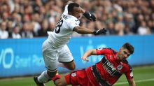 Swansea City's Jordan Ayew, left, and Huddersfield Town's Christopher Schindler clash in action during their English ...