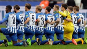 Solidarity: Hertha BSC Berlin kneel prior to their clash with FC Schalke.