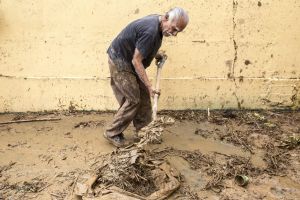 A resident shovels debris after Hurricane Maria in Arecibo, Puerto Rico, on Saturday, Sept. 23, 2017. Amid their ...