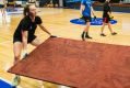 Workers remove panels to reveal the basketball court at the National Convention Centre.