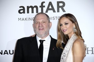 Producer Harvey Weinstein and stylist Georgina Chapman pose for photographers upon arrival for the amfAR Cinema Against AIDS benefit at the Hotel du Cap-Eden-Roc, during the 69th Cannes international film festival, Cap d'Antibes, southern France, Thursday, May 19, 2016.