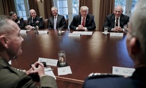 President Donald Trump, center, during a briefing with Senior Military leaders in the Cabinet Room of the White House in Washington, Thursday, Oct. 5, 2017.