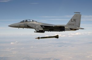 A US Air Force (USAF) F-15E Strike Eagle aircraft from the 492nd Fighter Squadron, Royal Air Force (RAF) Lakenheath, United Kingdom (UK) releases a GBU-28