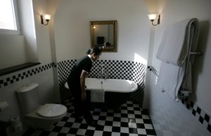 A chambermaid cleans a room at the American Colony hotel in Jerusalem Tuesday, Oct. 9, 2007.