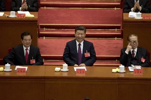 Chinese President Xi Jinping, center, sits with former Chinese President Hu Jintao at left and Jiang Zemin at right after delivering his speech at the opening ceremony of the 19th Party Congress held at the Great Hall of the People in Beijing, China, Wednesday, Oct. 18, 2017.