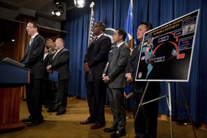 Deputy Attorney General Rod Rosenstein, left, accompanied by other law enforcement officials, speaks at a news conference at the Justice Department in Washington, Tuesday, Oct. 17, 2017, to announce two indictments of Chinese fentanyl trackers in the fight against opiate substances from entering the United States.