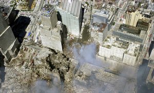 File - An aerial view, days after the 9-11 terrorist attacks on American soil, the towers of the World Trade Center (WTC) sit as a pile of rubble in the streets of New York City.