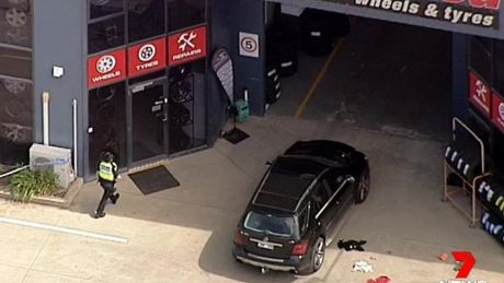 Shots have been fired into a tyre business in Melbourne's west, injuring two people. 