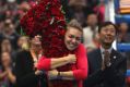 On top of the world: Simona Halep of Romania hugs a floral bouquet in the shape of the number one after beating Jelena ...