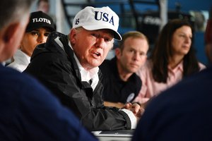 President Donald Trump is briefed by Coast Guard Atlantic Area Commander Vice Admiral Karl Schultz during a Hurricane Harvey response update from federal, state and local agencies and relief organizations at Fire Station 5 in Corpus Christi, Texas, August 29, 2017.