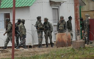 Indian army soldiers patrol inside the Rashtriya Rifles army camp at Safapora some 20 kms (12 miles) from Srinagar on February 27, 2014. A soldier in Indian Kashmir shot dead five of his colleagues before killing himself, an incident which experts said highlights the stress facing troops in the volatile region bordering Pakistan. The soldier was on night duty when he opened fire on his colleagues who were reportedly sleeping in their barracks at a military camp, 20 kilometres (12 miles) north of the region's main city of Srinagar.