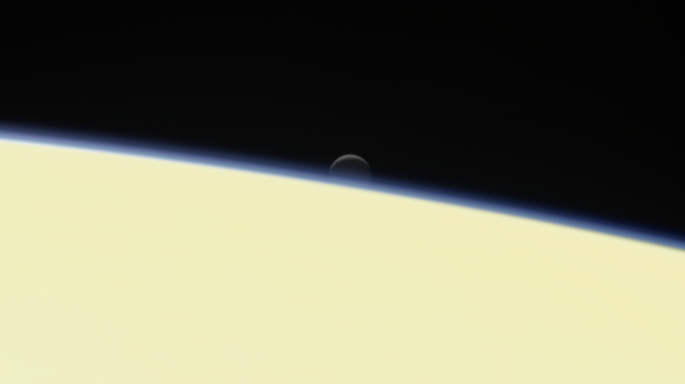 The moon Enceladus sets behind Saturn. This is one of the last images Cassini took.