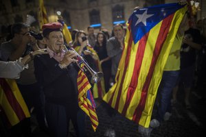 People gather in front of the Palau Generalitat in Barcelona, Spain awaiting for Catalan President Carles Puigdemont's speech Saturday, Oct. 21, 2017.