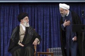 In this picture released by official website of the office of the Iranian supreme leader, Supreme Leader Ayatollah Ali Khamenei, left, and President Hassan Rouhani greet at the official endorsement ceremony of President Rouhani in Tehran, Iran, Thursday, Aug. 3, 2017.