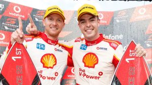 All smiles: Scott McLaughlin and Alex Premat of DJR Team Penske on the podium after their round 22 win in the Gold Coast 600.
