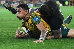 Seizing the moment: Israel Folau shows a look for sheer determination after scoring against the All Blacks.