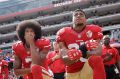 Colin Kaepernick (left) and Eric Reid kneel during the national anthem in October 2016.