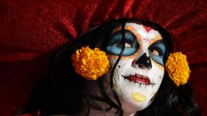 A woman dressed as Mexico's iconic "Catrina" awaits the start of the Grand Procession of the Catrinas, part of upcoming ...