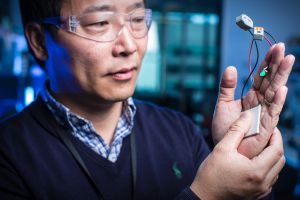 Jun Chen demonstrates wearable tech at the Australian Institute for Innovative Materials Intelligent Polymer Research ...