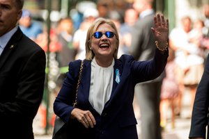 Democratic presidential candidate Hillary Clinton waves after leaving an apartment building Sunday, Sept. 11, 2016, in New York.