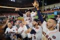 Houston's Jose Altuve is lifted by teammates after game seven.