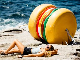 Artist James Dive with his sculpture of a giant hamburger at Sculpture By the Sea. Also Linton Meagher with his sculpture of a lifesavers' tower.