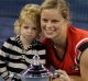 Kim Clijsters with her daughter Jada and the US Open trophy in 2009. Clijsters is one of three women who have won grand ...