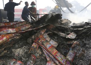 Firefighters work at the site of an explosion at a firecracker factory in Tangerang, on the outskirt of Jakarta, Indonesia, Thursday, Oct. 26, 2017.