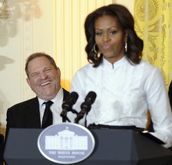 Movie mogul Harvey Weinstein, left, listen as first lady Michelle Obama speaks in the East Room of the White House in Washington, Friday, Nov. 8, 2013, at a workshop for high school students from Washington, New York and Boston about careers in film.