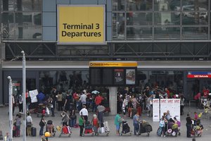 Passengers queue outside Terminal 3 at Heathrow Airport in London, Friday, July 12, 2013.