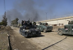 Iraqi security forces advance during fighting against Islamic State militants, in western Mosul, Iraq, Monday, March 6, 2017.