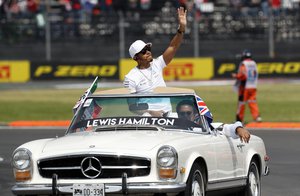 Lewis Hamilton, of Britain, waves to the crowd from a classic Mercedes car before the Formula One Mexico Grand Prix