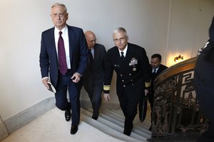 Defense Secretary James Mattis, left, walks up the stairs in the Russell Senate Office, Friday, Oct. 20, 2017, for a meeting with Sen. John McCain, R-Ariz., about Niger.