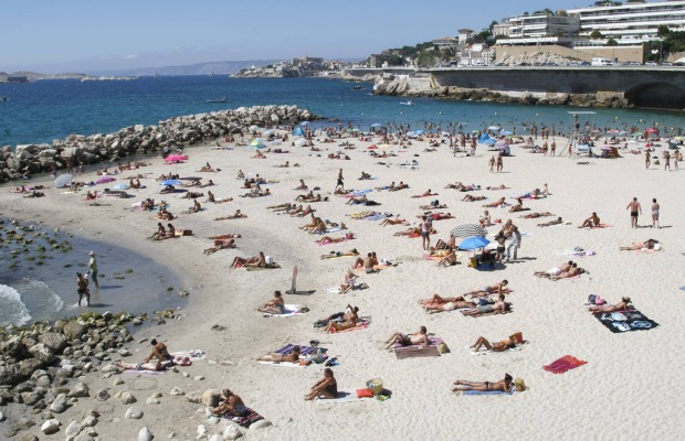 People bathe at the Prophet beach in Marseille, southern France.