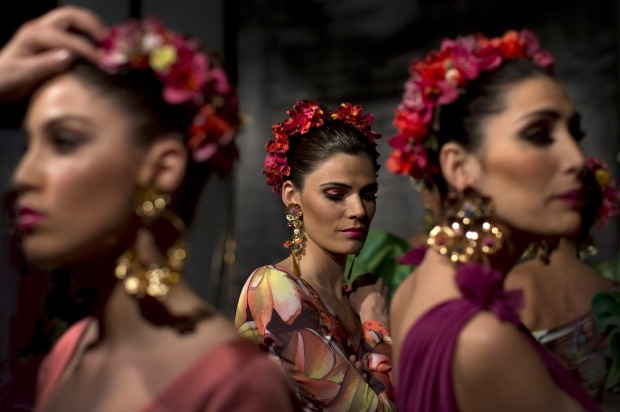Models wait in backstage during the first day of the SIMOF 2015 in Seville, Spain.