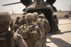 File - U.S. Marine advisors board a CH-47 Chinook helicopter after a train, advise and assist mission at the Helmand Provincial Police Headquarters in Lashkar Gah, Afghanistan, July 9, 2017.