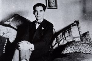 Federico Garcia Lorca at home in Granada in 1925, beneath one of several paintings Salvador Dali gave him in the mid-1920s. 