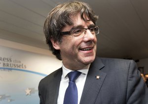 Sacked Catalonian President Carles Puigdemont smiles after a press conference in Brussels, Tuesday, Oct. 31, 2017. Ousted Catalan President Carles Puigdemont is calling for avoiding violence and says dialogue is a priority during his first address on Belgian soil. Puigdemont on Tuesday recapped the issues which led him to leave for Belgium the previous day, but did not immediately say in his statement what he would do in Brussels or whether he would seek asylum. (AP Photo/Olivier Matthys)