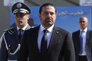 In this photo taken on Friday, Sept. 8, 2017, Lebanese Prime Minister Saad Hariri, left, arrives for a mass funeral of ten Lebanese soldiers at the Lebanese Defense Ministry, in Yarzeh near Beirut, Lebanon. Lebanese prime minister Saad Hariri has announced he is resigning in a surprise move following a trip to Saudi Arabia. In a televised address Saturday, Nov. 4, he slammed Iran and the Lebanese Hezbollah group for meddling in Arab affairs and says "Iran's arms in the region will be cut off."