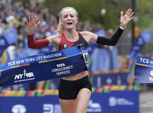 Shalane Flanagan of the United States crosses the finish line first in the women's division of the New York City Marathon in New York