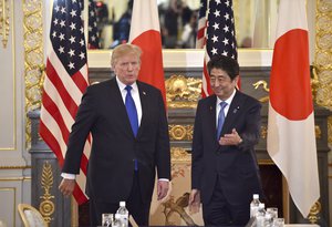 U.S. President Donald Trump, left, is gestured by Japanese Prime Minister Shinzo Abe prior to their meeting at Akasaka Palace in Tokyo Monday, Nov. 6, 2017.