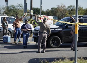 Law enforcement officers man a barricade near the First Baptist Church of Sutherland Springs in response to a shooting