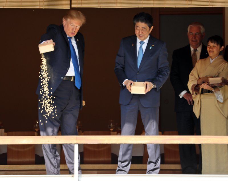 Trump was just copying his host when he 'overfed' fish in Japan