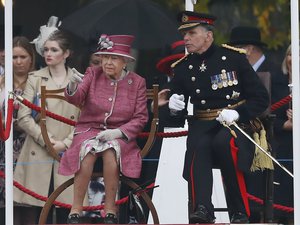 Britain's Queen Elizabeth II reacts as she reviews The King's Troop Royal Horse Artillery (KTRHA) in Hyde Park, during their 70th Anniversary in London, Thursday, Oct. 19, 2017.