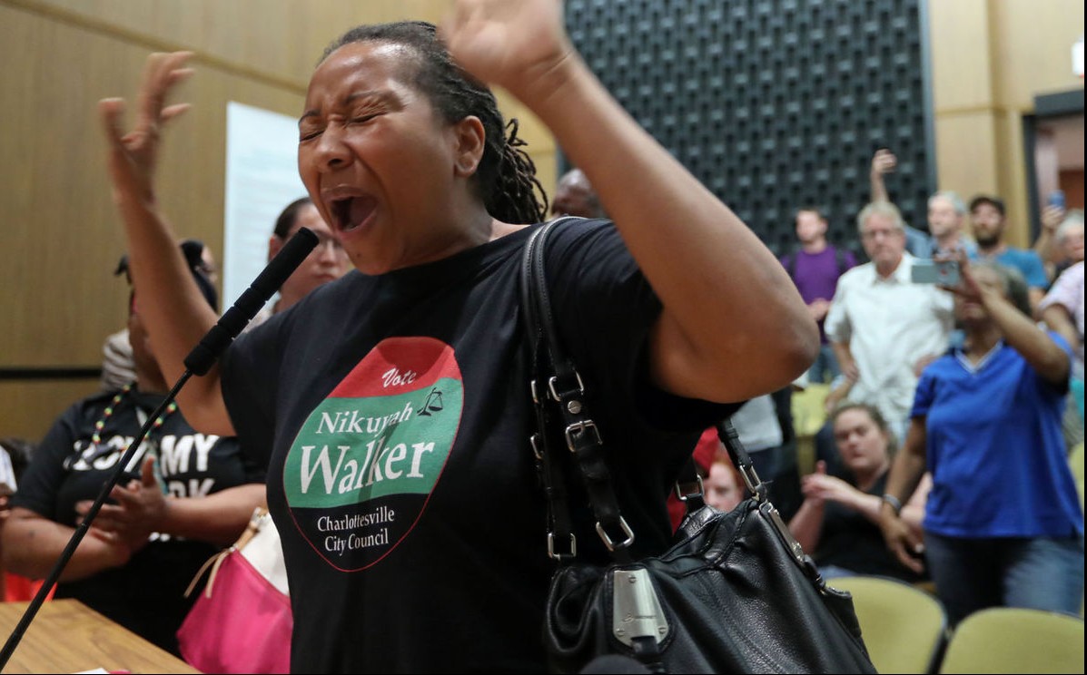 City council candidate Nikuyah Walker shouts into a microphone at a City Council meeting after a white supremacist rally in Charlottesville.