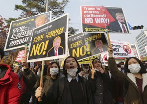 Members of “No Trump Coalition” shout slogans during a rally to oppose a visit by the U.S. President Donald Trump in front of the National Assembly in Seoul, South Korea, Wednesday, Nov. 8, 2017.