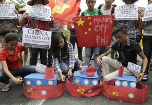 Filipino student activists set fire mock Chinese ships to protest recent island-building and alleged militarization by China off the disputed Spratlys group of islands in the South China Sea during a rally near the Malacanang presidential palace in Manila, Philippines, Thursday, March 3, 2016.