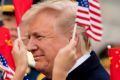 Children wave US and Chinese flags as President Donald Trump arrives at Beijing Airport.