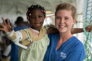 Mercy Ships ward nurse Theresa Bode takes a patient for a walk on deck.